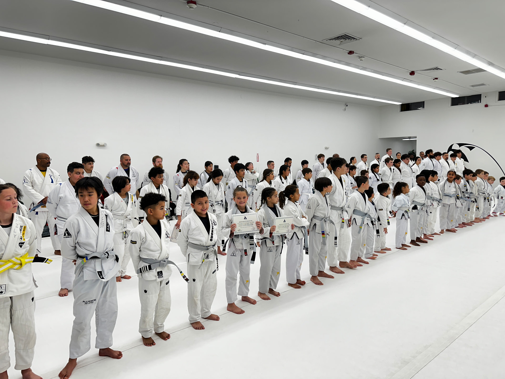 Students of all ages standing in line during a graduation ceremony