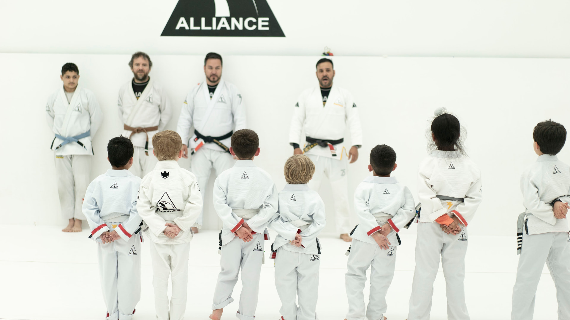 Kids class lined up facing the instructors at the start of class